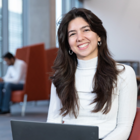 student sitting inside with laptop